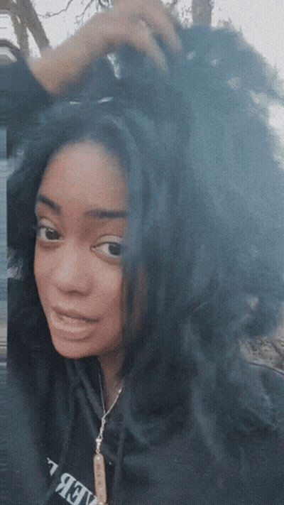 A Woman Wearing A Black Sweatshirt That Says Believe GIF