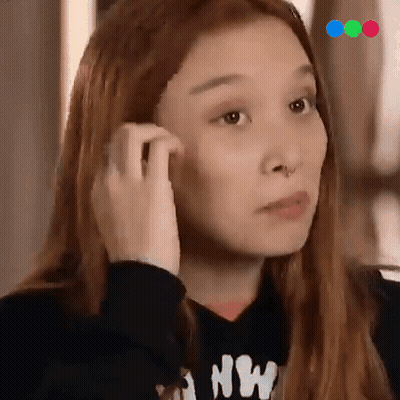 A Woman Wearing A Black Sweatshirt With The Letter Nw On It GIF