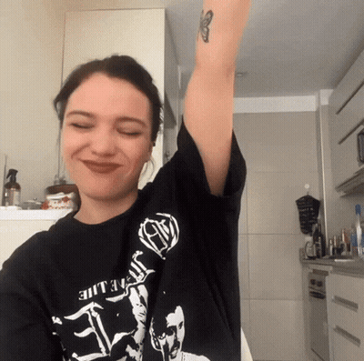 A Woman Wearing A Black T-Shirt That Says ' Death ' On It GIF