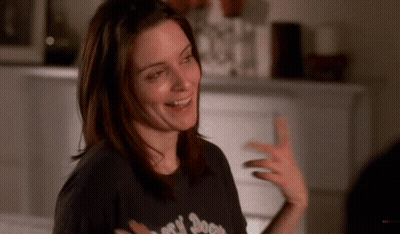 A Woman Wearing A Black T-Shirt That Says ' Rock N ' Roll ' On It GIF