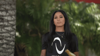 A Woman Wearing A Black T-Shirt With A White Letter C On It GIF