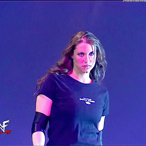 A Woman Wearing A Black T-Shirt With The Word Wrestling On The Front GIF