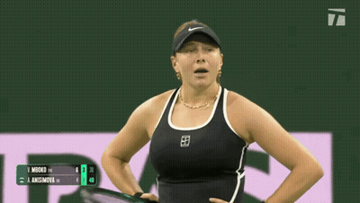 A Woman Wearing A Black Tank Top And A Visor Stands On A Court GIF