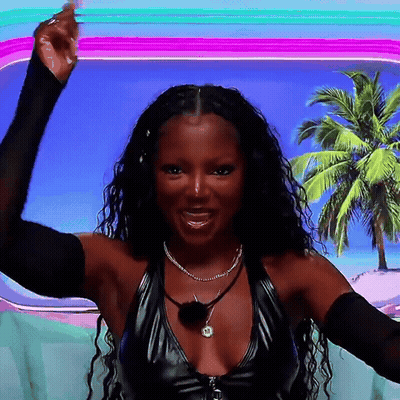 A Woman Wearing A Black Top With A Necklace That Says ' A ' On It GIF