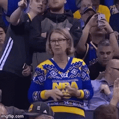A Woman Wearing A Blue And Yellow Sweater With Nba On It GIF