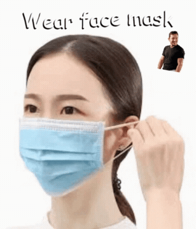 A Woman Wearing A Blue Face Mask With A Man Standing Behind Her . GIF