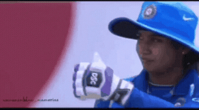 A Woman Wearing A Blue Hat And Gloves With Dsc On Them GIF