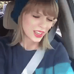A Woman Wearing A Blue Hat Is Sitting In A Car With A Seat Belt On . GIF