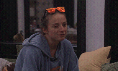 A Woman Wearing A Blue Hoodie And Orange Sunglasses GIF