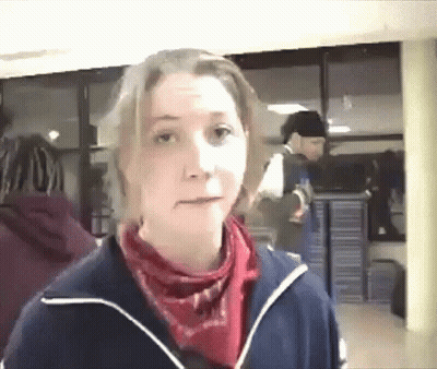 A Woman Wearing A Blue Jacket And A Red Scarf GIF