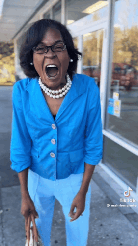 A Woman Wearing A Blue Jacket And Blue Pants Is Screaming GIF
