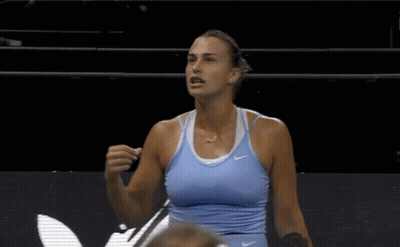A Woman Wearing A Blue Nike Tank Top Stands On A Court GIF