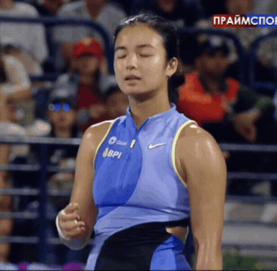 A Woman Wearing A Blue Nike Tank Top With Bpi Written On It GIF