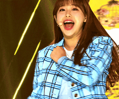 A Woman Wearing A Blue Plaid Jacket Is Laughing With Her Mouth Wide Open GIF