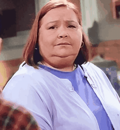 A Woman Wearing A Blue Shirt And A Blue Cardigan GIF