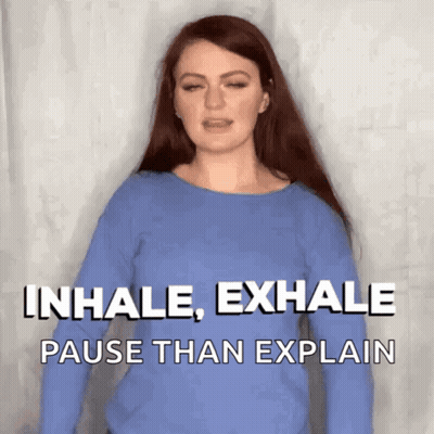 A Woman Wearing A Blue Shirt Says Inhale Exhale Pause Than Explain GIF