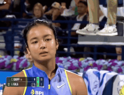 A Woman Wearing A Blue Shirt That Says Bpi On It Looks At The Camera GIF
