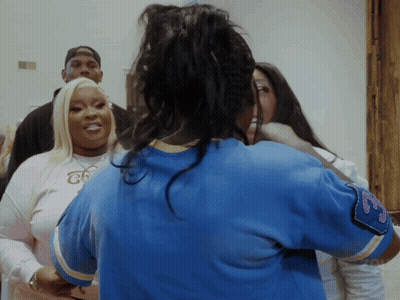 A Woman Wearing A Blue Shirt That Says ' Chicago ' On The Sleeve GIF