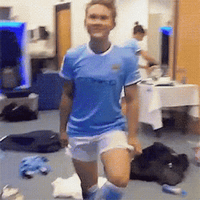 A Woman Wearing A Blue Shirt That Says City On It GIF