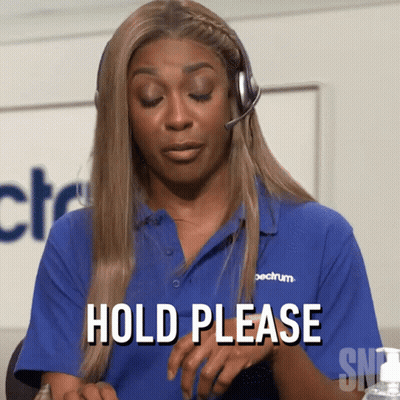 A Woman Wearing A Blue Shirt That Says Hold Please GIF