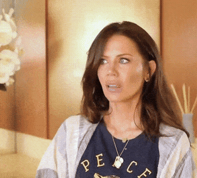 A Woman Wearing A Blue Shirt That Says Peace On It GIF