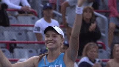 A Woman Wearing A Blue Shirt That Says ' Reebok ' On It GIF