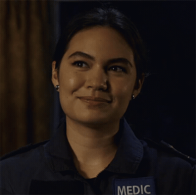 A Woman Wearing A Blue Shirt With A Patch That Says Medic On It GIF