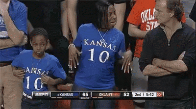 A Woman Wearing A Blue Shirt With Kansas 10 On The Front GIF