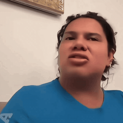 A Woman Wearing A Blue Shirt With The Letter A On The Front GIF