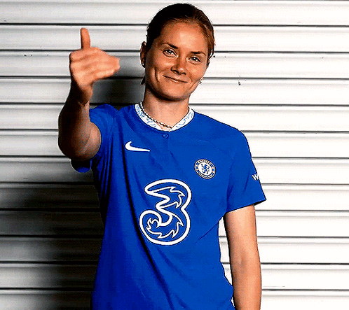 A Woman Wearing A Blue Shirt With The Number 3 On It Is Giving A Thumbs Up GIF