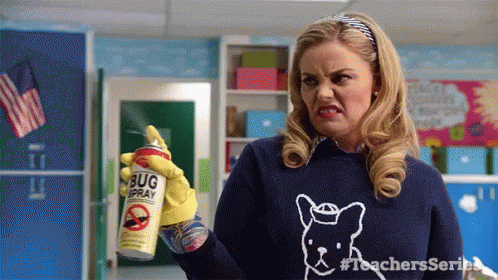 A Woman Wearing A Blue Sweater With A Dog On It Is Holding A Can Of Bug Spray . GIF