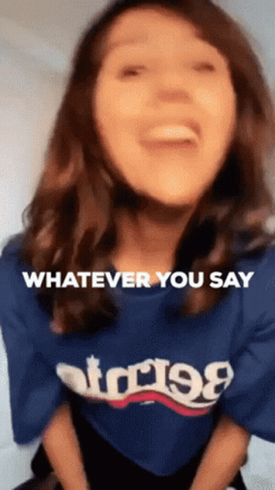 A Woman Wearing A Blue T-Shirt That Says Whatever You Say GIF