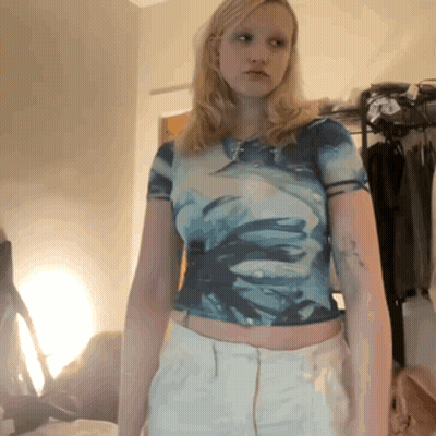 A Woman Wearing A Blue Tie Dye Crop Top And White Pants GIF