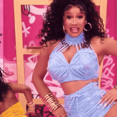 A Woman Wearing A Blue Top And Shorts Is Dancing GIF