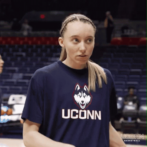 A Woman Wearing A Blue Uconn Shirt With A Husky On It GIF