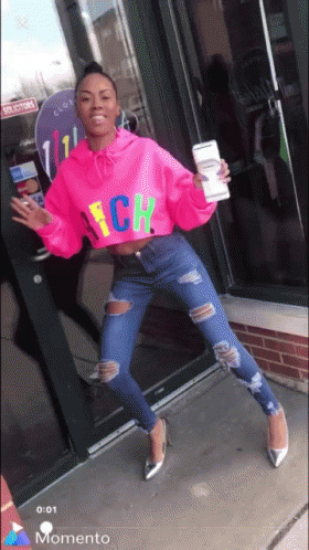 A Woman Wearing A Bright Pink Sweater That Says Nch GIF