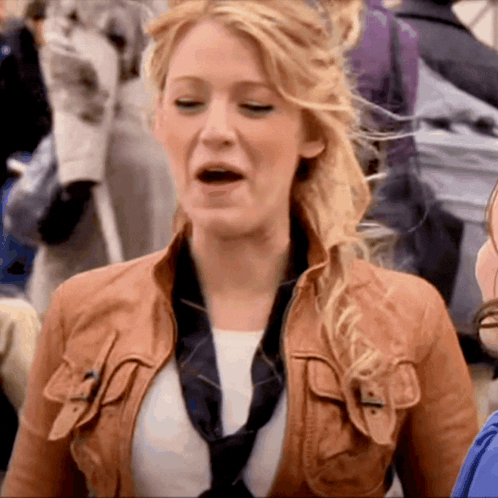 A Woman Wearing A Brown Leather Jacket And A Black Tie GIF