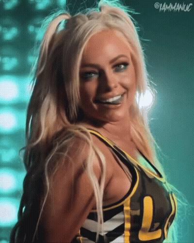 A Woman Wearing A Camo Top With The Letters L On It GIF