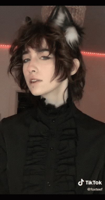 A Woman Wearing A Cat Ear Headband And A Black Shirt With Tiktok Written On The Bottom Right GIF