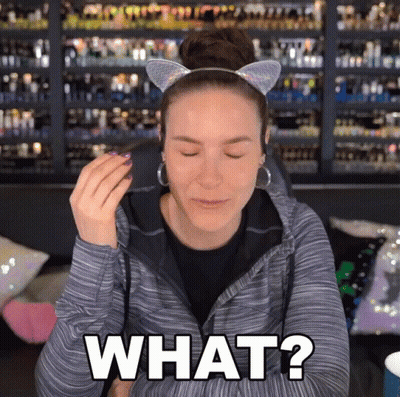 A Woman Wearing A Cat Ear Headband Is Asking What GIF