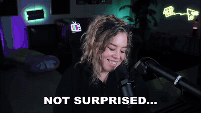 A Woman Wearing A Cat Ear Headband Is Talking Into A Microphone And Says Not Surprised GIF