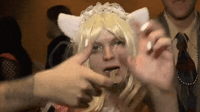 A Woman Wearing A Cat Ear Wig Is Being Touched By Someone 'S Hand GIF