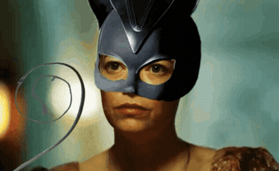 A Woman Wearing A Cat Mask Has A Swirl Around Her Neck GIF