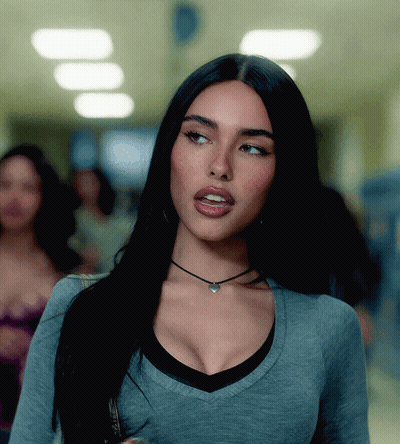 A Woman Wearing A Choker Necklace And A Gray Shirt GIF