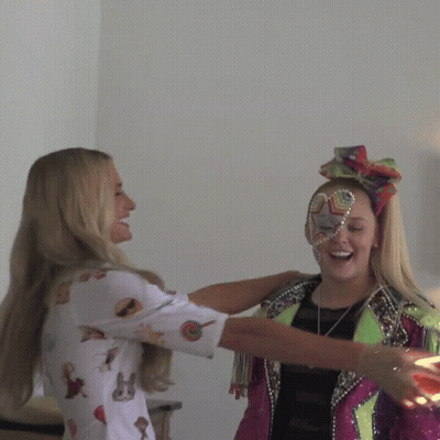 A Woman Wearing A Colorful Headband With The Letter O On It GIF