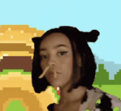 A Woman Wearing A Cow Costume Is Eating French Fries . GIF