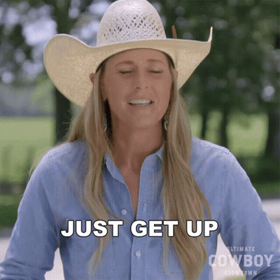 A Woman Wearing A Cowboy Hat And A Blue Shirt Says " Just Get Up " GIF
