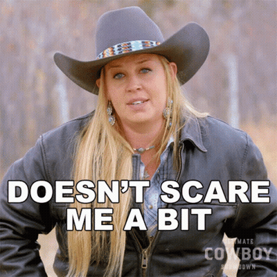 A Woman Wearing A Cowboy Hat Says " Doesn 'T Scare Me A Bit " GIF
