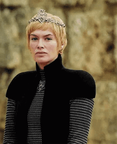 A Woman Wearing A Crown And A Black Vest Is Standing In Front Of A Wall . GIF