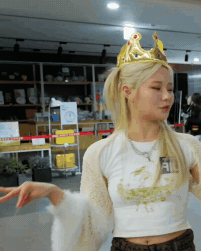 A Woman Wearing A Crown And A White Crop Top GIF